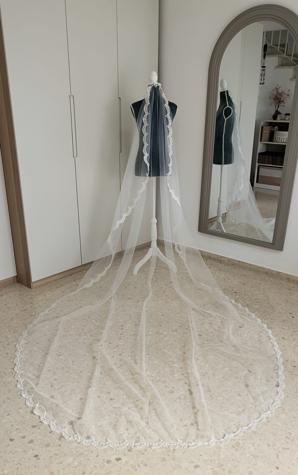 Vista aérea de la cola extendida de un velo de novia de 2x3 metros en tul soft blanco natural con encaje de pedrería fina.